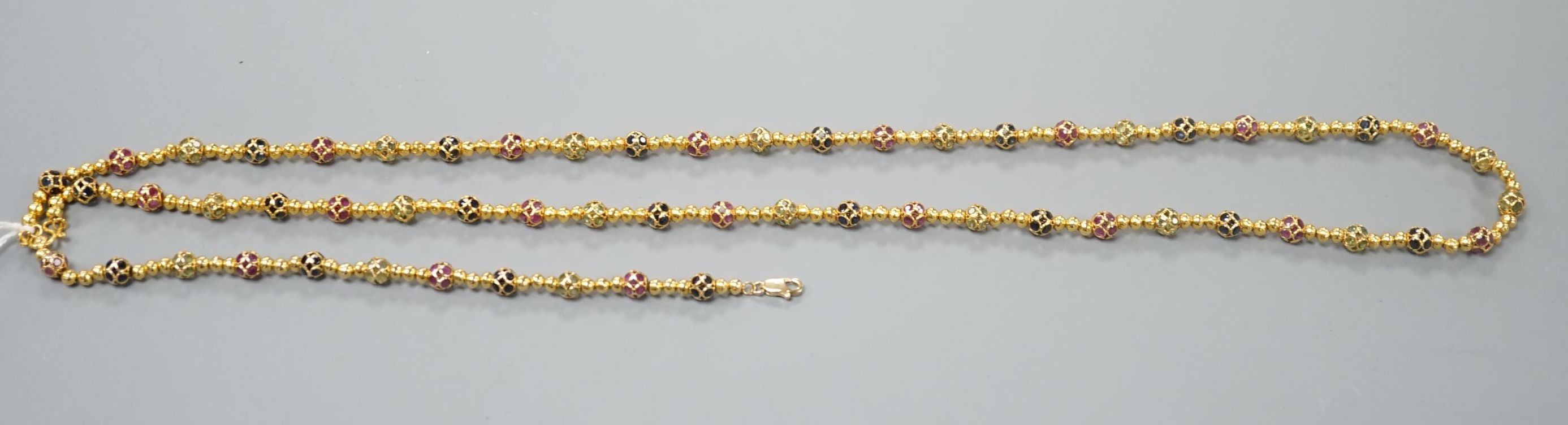 A modern Thai yellow metal and gem set spherical link necklace, 72cm and a similar bracelet stamped 585, 17.5cm, gross weight 35.4 grams.